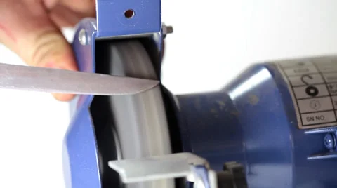 Sharpening kitchen knife on grindstone Stock Footage 35713831