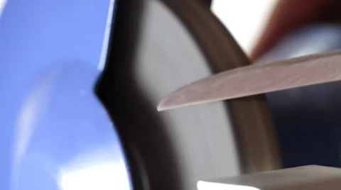 Sharpening kitchen knife on grindstone Stock Footage 35713841