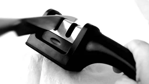 Sharpening a kitchen knife in a manual knife sharpener Video stock 204011683