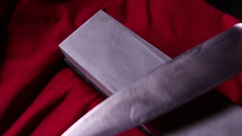 Sharpening kitchen knife on a whetstone. 4K UHD Stock Footage 73020791