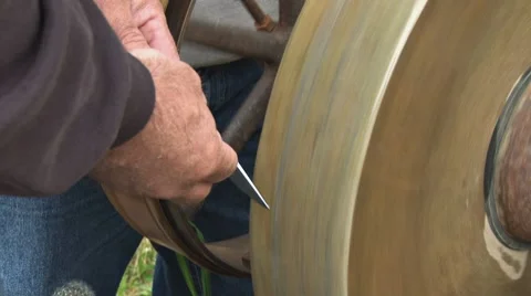 Sharpening Knife at Grindstone 1 Stock Footage 8532381