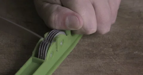 Sharpening a knife in the kitchen Stock Footage 126652255
