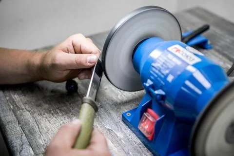 Sharpening the knife with a special machine Stock Photos