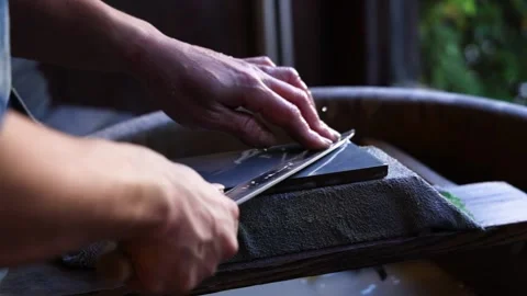 Sharpening Knife on Stone in Sequence Stock Footage 297446681