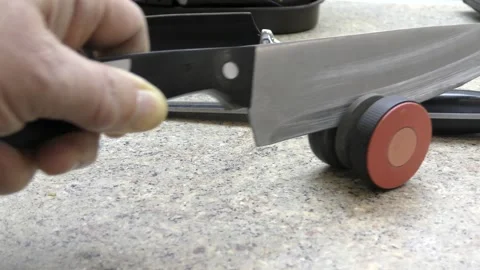 Sharpening a knife on a whetstone by hand. Stock Footage 149476501