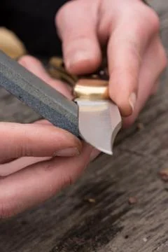 Sharpening knife on whetstone Stock Photos
