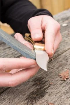 Sharpening knife on whetstone Stock Photos