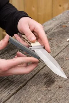 Sharpening knife on whetstone Stock Photos