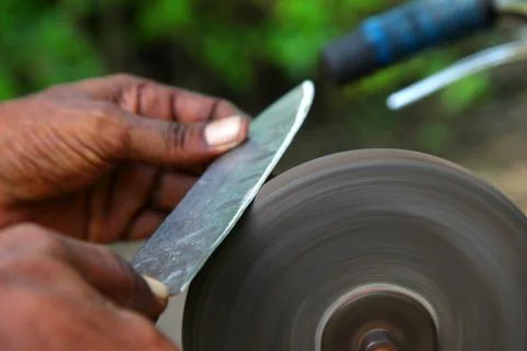 Sharpening the knife with whetstone Stock Photos