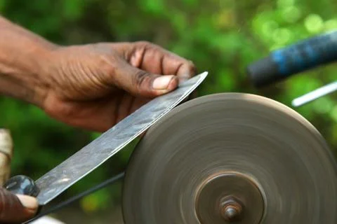 Sharpening the knife with whetstone Stock Photos