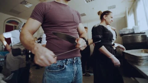Sharpening knives in the catering kitchen Stock Footage 167484276