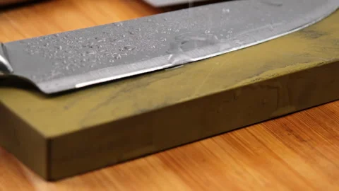 Sharpening knives with a Whetstone. Knife sharpening.  Stock Footage 248340443