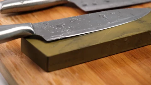 Sharpening knives with a Whetstone. Knife sharpening.  Stock Footage 248340597