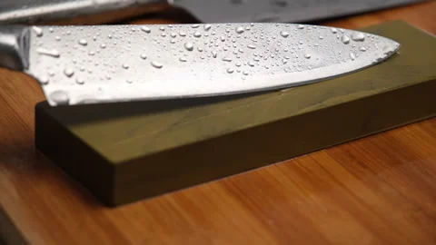 Sharpening knives with a Whetstone. Knife sharpening.  Stock Footage 248340602