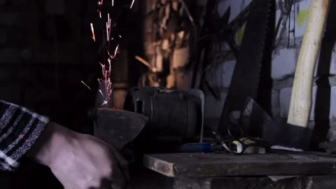 Sharpening an old grain ax close-up with bright sparks Stock Footage 135654866
