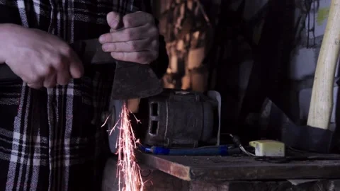 Sharpening an old grain ax close-up with bright sparks Stock Footage 140108520