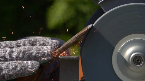 Sharpening of old grange ax with unbalanced grinding machine in slow motion. Stock-Footage 98677778
