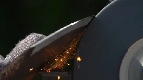 Sharpening of old grange ax with unbalanced grinding machine in slow motion. Stock Footage 98678247