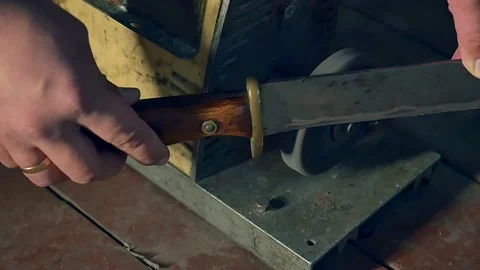 Sharpening the old knife on the grinding machine. Close-up. Slow motion Stock Footage 98212852