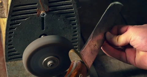 Sharpening the old knife on the grinding machine. Close-up Stock Footage 98213012