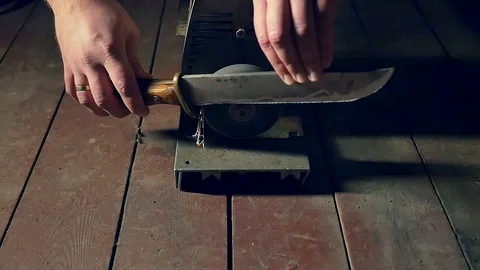 Sharpening the old knife on the grinding machine. Close-up. Slow motion Video stock 98213704