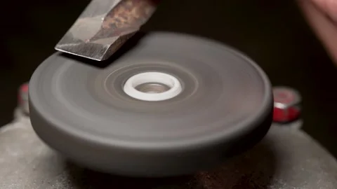 Sharpening a part on a grinding wheel Stock Footage 169835238