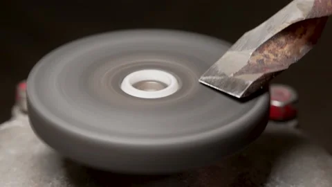 Sharpening a part on a grinding wheel Stock Footage 169835463