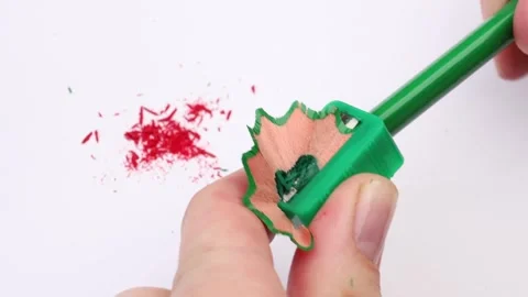 Sharpening a pencil with a sharpener on white paper, the pencil is now ready Video stock 287565961