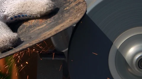 Sharpening of soiled garden tool with grinding machine in slow motion close up. Stock Footage 98677590