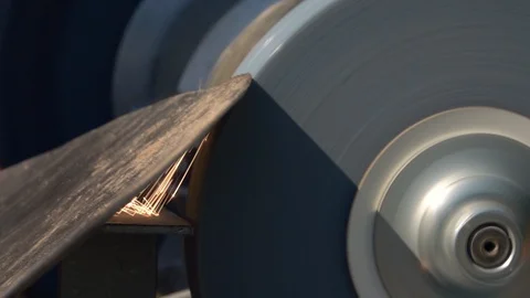 Sharpening of soiled garden tool with unbalanced grinding machine close up. Stock Footage 98676386