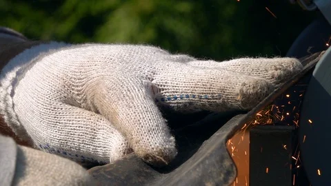 Sharpening of soiled garden tool with unbalanced grinding machine in slow motion Stock Footage 98677622