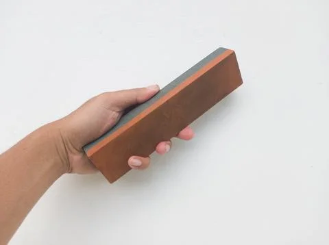 Sharpening stone held in hand Stock Photos