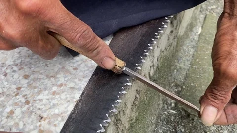 Sharpening a wood saw Stock Footage 303085224