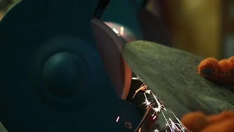 Sharpening work with a grinding wheel. Hands of a man sharpening a shovel wit Stock Footage 187159241