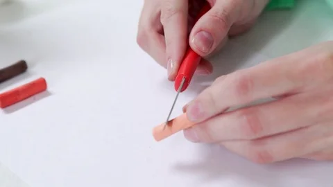 Sharpens the red pastel chalk and collects crumbs to make the shadin Video stock 79446093
