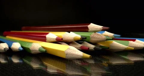 Sharply sharpened multi-colored pencils on black background. Colored Art Pencils Stock Footage 146796433