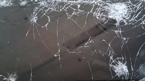 Shattered glass screen texture with complex white spiderweb crack patterns Stock Photos