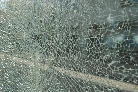 Shattered Glass Texture with Angular Cracks and Bright Reflections Stock Photos