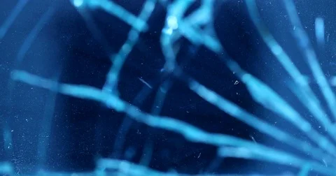 Shattering glass on blue background. Breaking window screen. Stock Footage