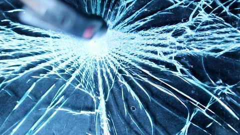 Shattering glass screen with a hammer. Breaking and cracking screen on grunge Stock Footage 118670779