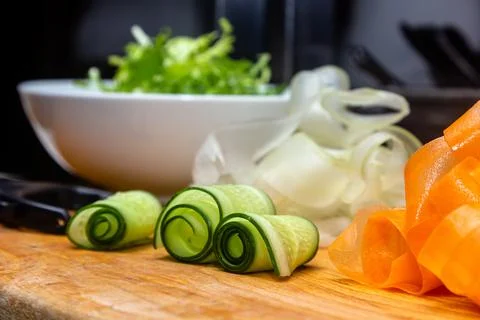 Shaved cucumber strips on white Stock Photos