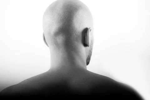 Shaved head behind statue clean baldness skinhead Stock-Fotos