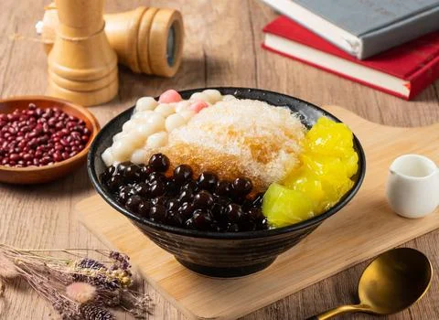 Shaved Ice with mango, red beans and rice ball served in bowl isolated on tab Stock Photos