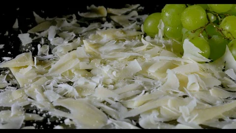 Shaved Parmesan cheese falls down and gets picked up Stock Footage 104856197