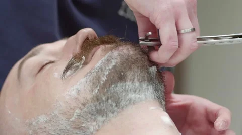 Shaving the beard in the Barber shop. Left angle. Medium Shot Stock Footage 58491783