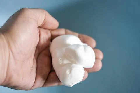 Shaving foam in hand Stock Photos