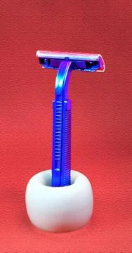 Shaving machine made of blue plastic, standing in a white porcelain stand. Stock Photos
