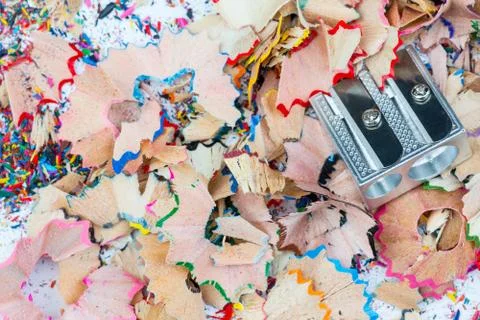 Shavings and sharpener on grey background Foto stock
