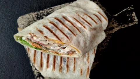 Shawarma with chicken or beef, tortilla roll, and vegetables. Shawarma with meat Stock Footage 320169057