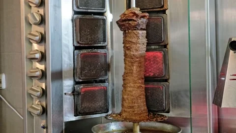 Shawarma (doner kebab) rotating on grill oven Stock Footage 221640949